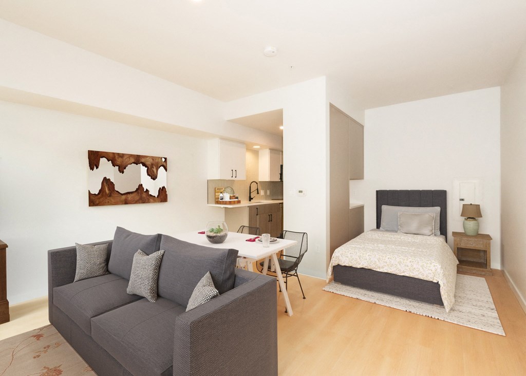 a bedroom with a bed and a couch and a dining table