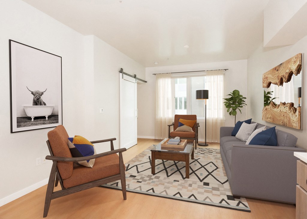 a living room with a couch and chairs and a table