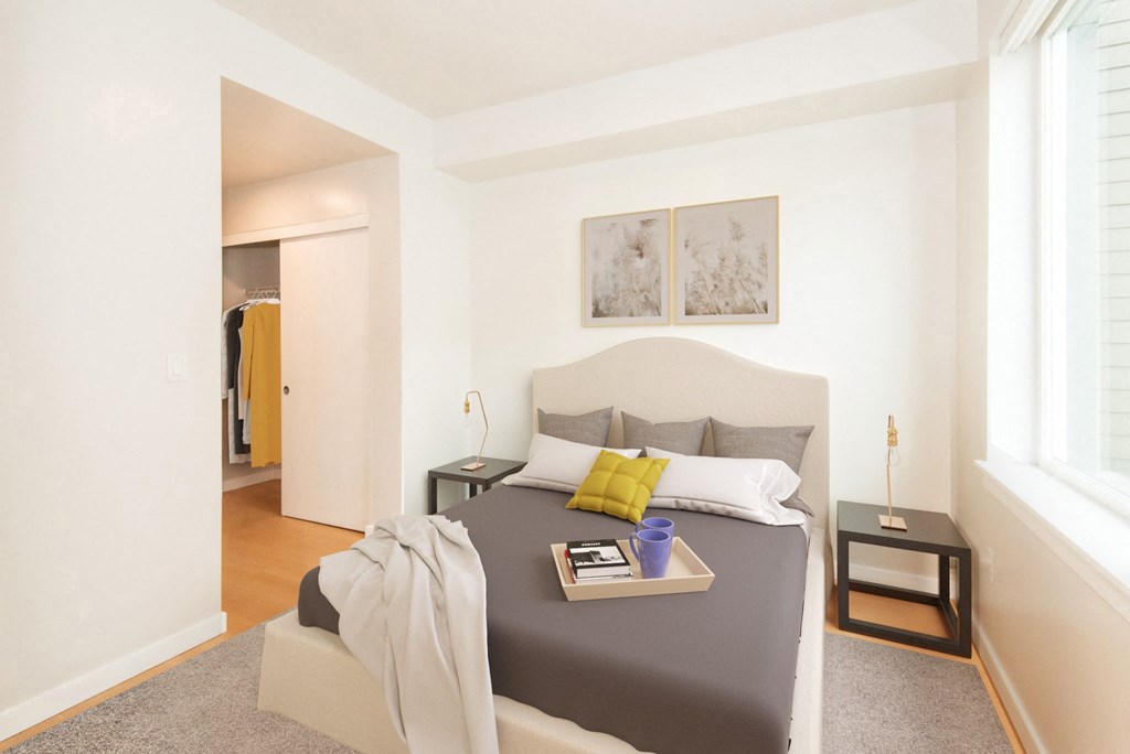 a bedroom with a large bed and a window