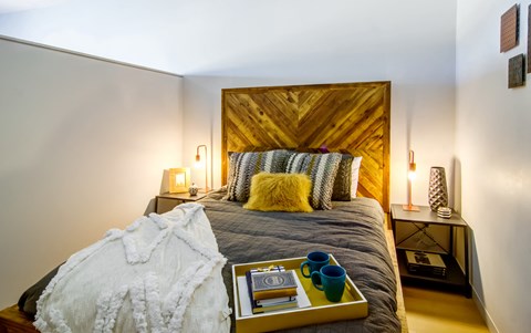 Bedroom with full bed and bedside tables on either side