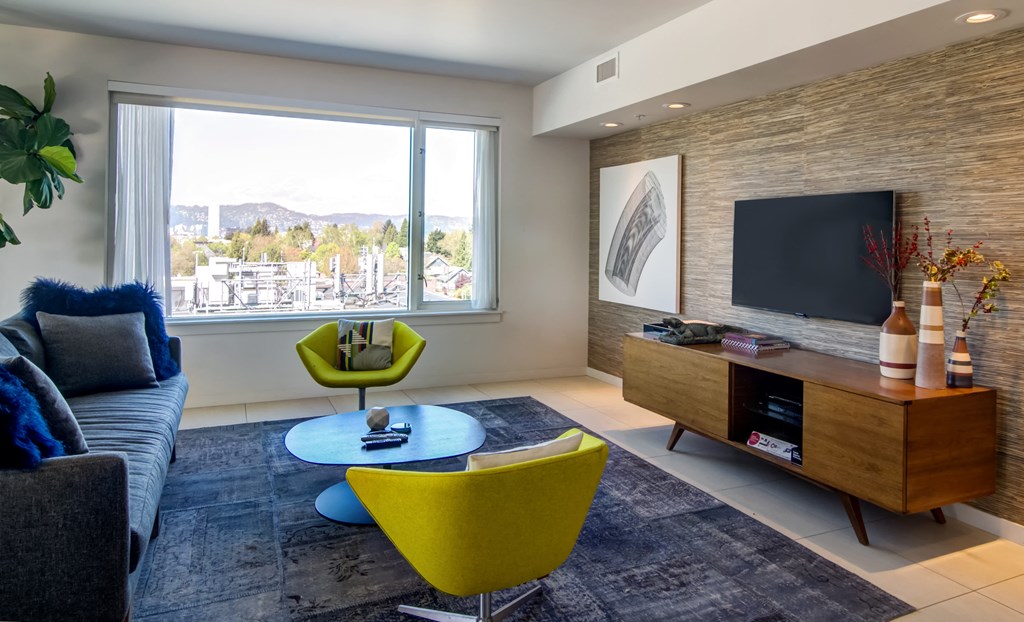 Rooftop indoor clubhouse area with tv and chairs