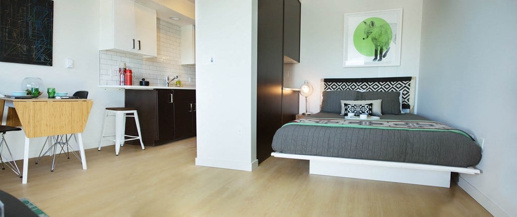 King bed in separated area to kitchen and dining table