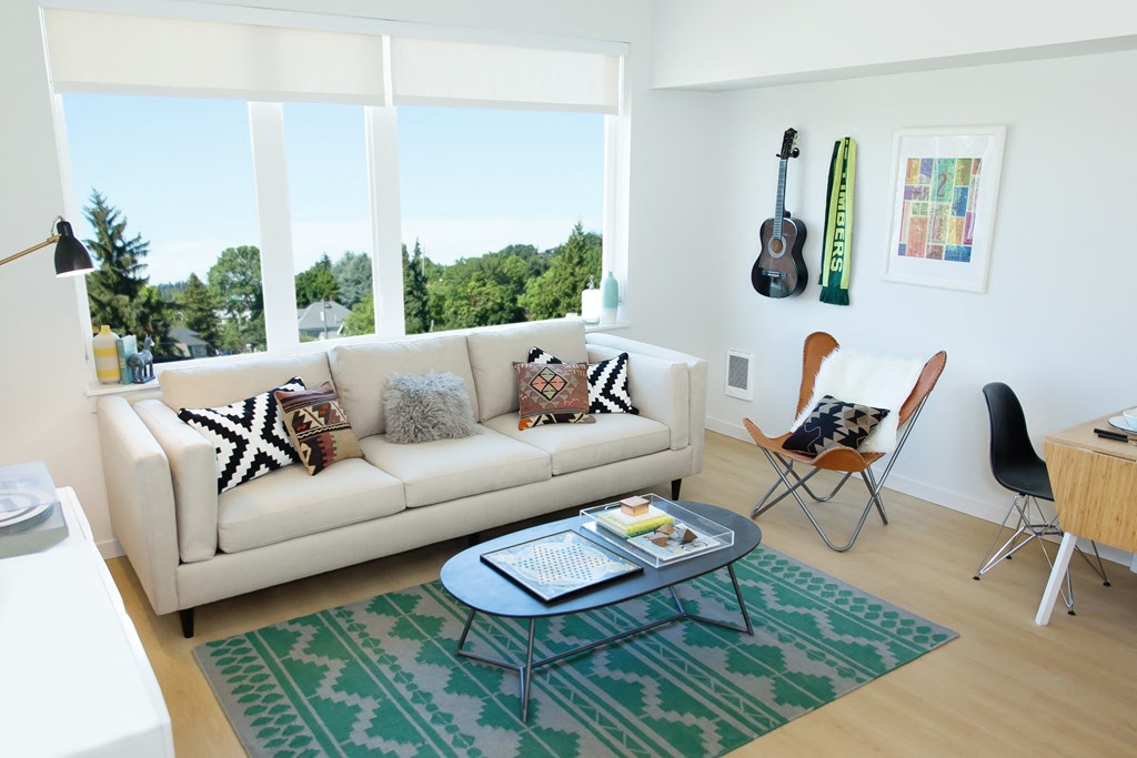 Unit living area with large window over spacious seating area