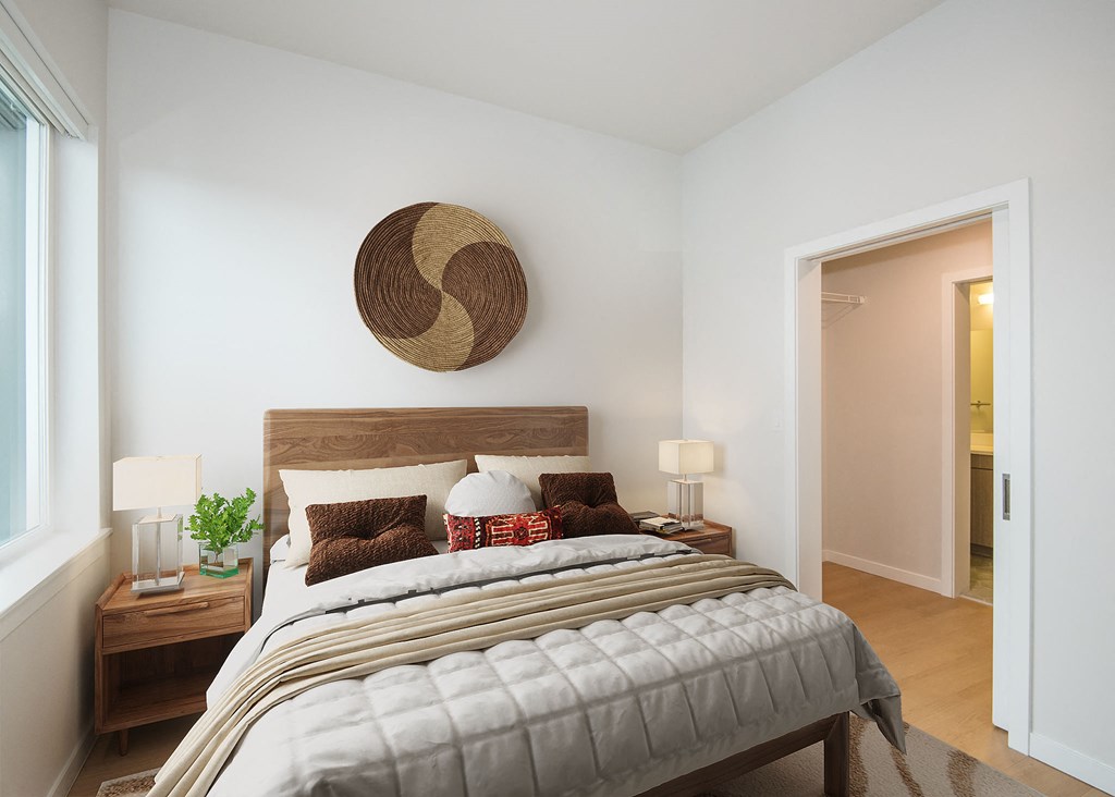 a bedroom with a bed and a door to a bathroom