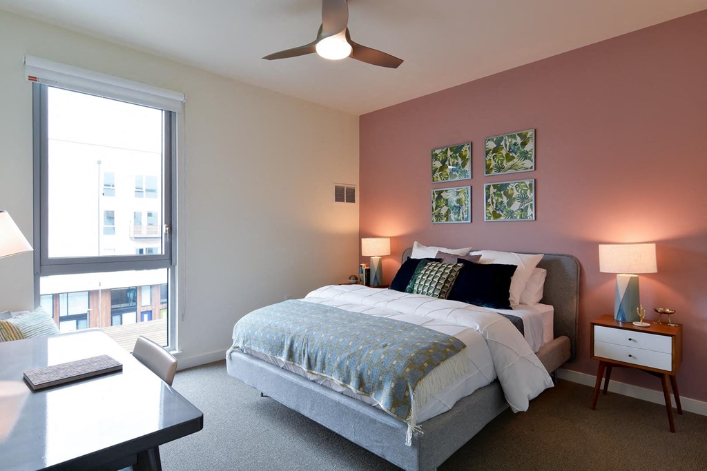 Bedroom with full bed and large window