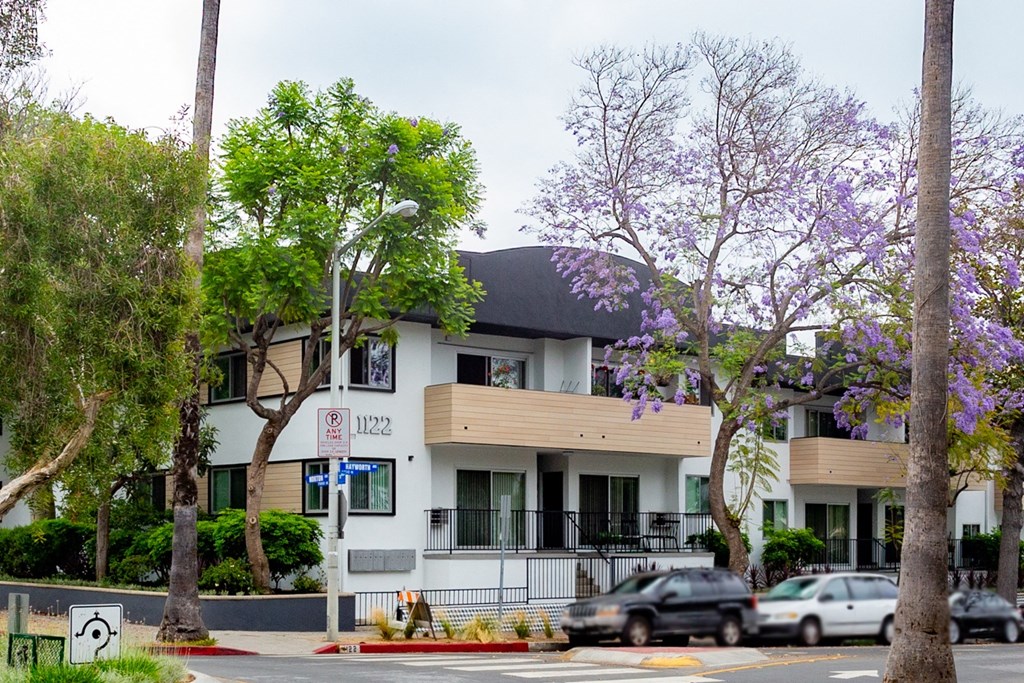 Exterior with unit patios and trees around property