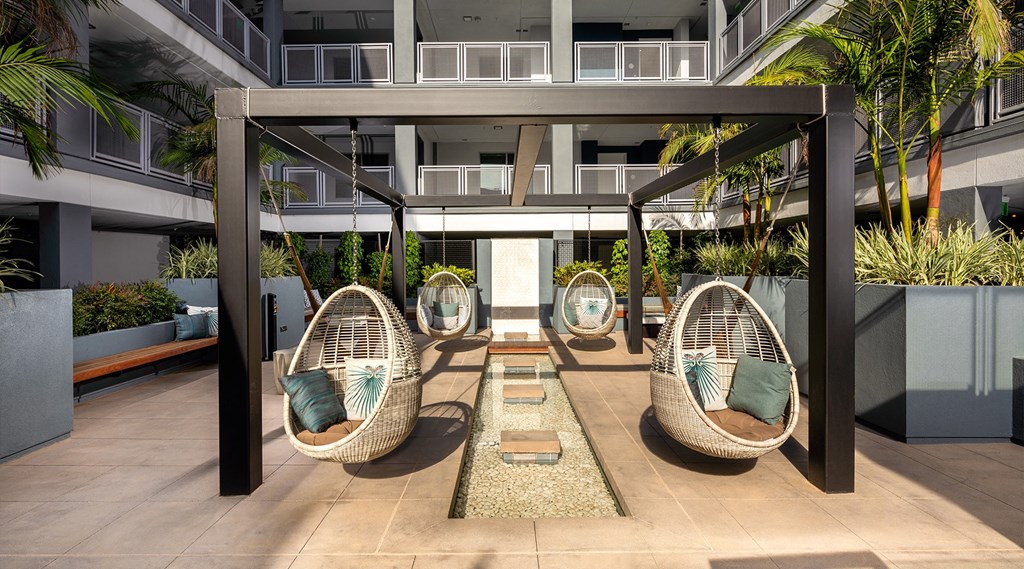 Outdoor lounge with hanging egg chairs