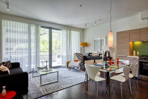 A modern kitchen with a glass table and chairs.