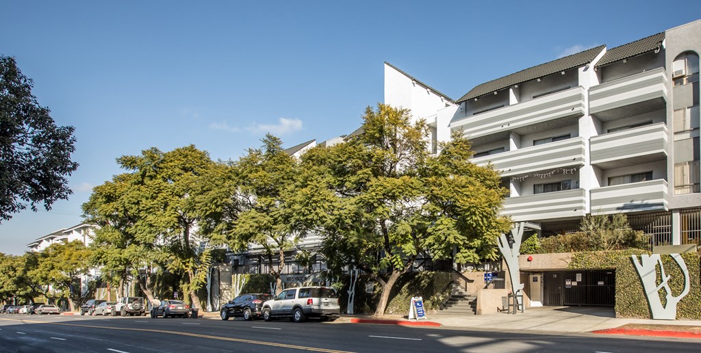 Exterior on a Sunny Day with First Floor Parking Garage