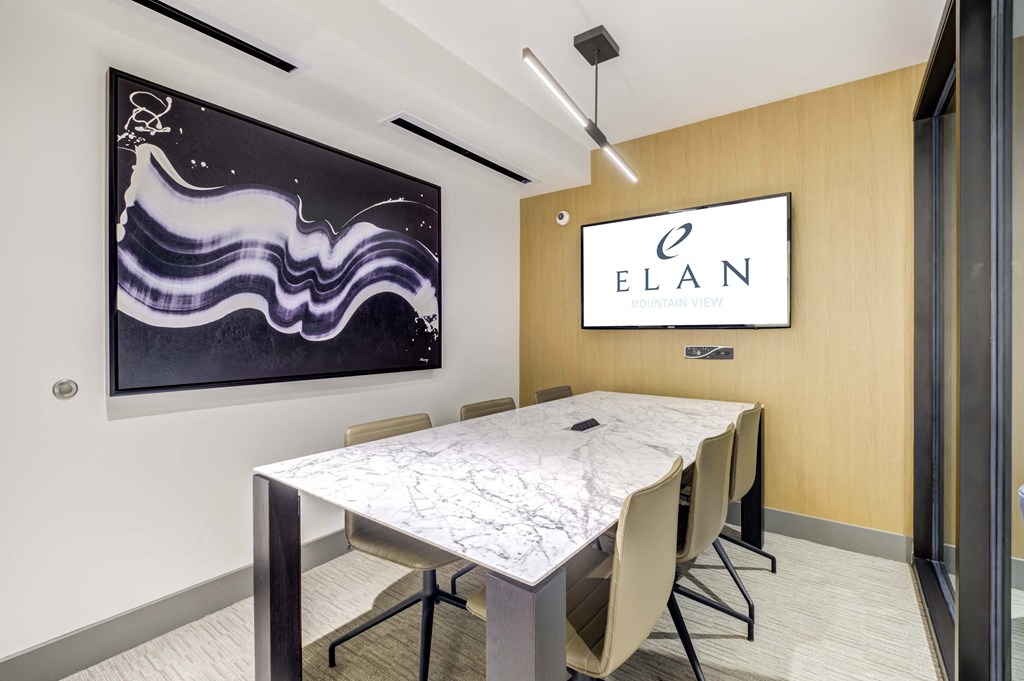 Sleek Conference Room with Long Table and Screen