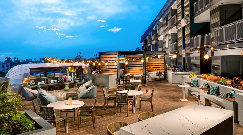 Beautiful outdoor rooftop lounge with tables and seating and string lights