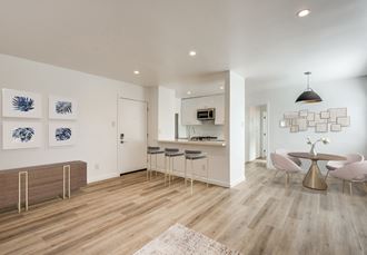 Spacious open floor plan with kitchen, dining area, and living room
