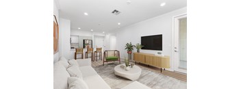 a living room with white walls and a white couch