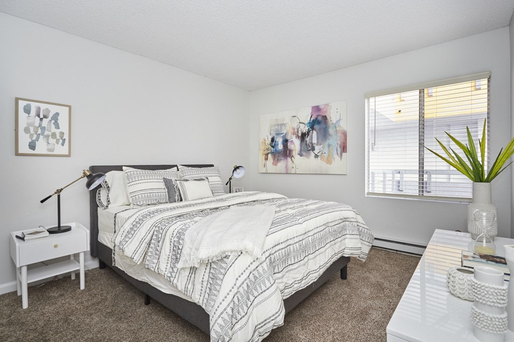 Brightly-Lit Bedroom with Queen Bed and Desk