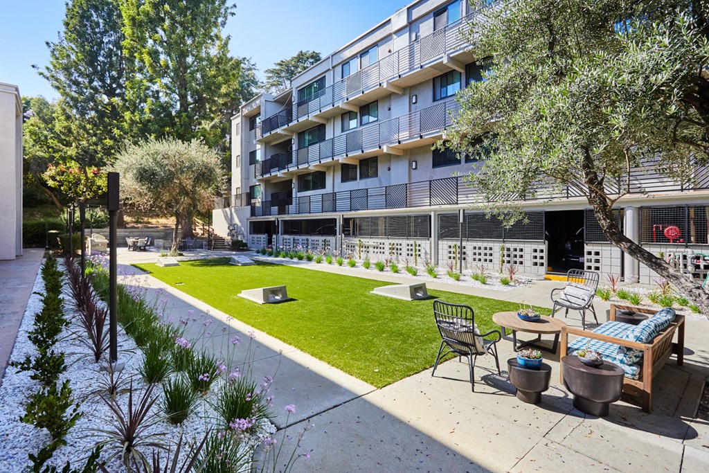 Outdoor lounge area with lawn games and seating