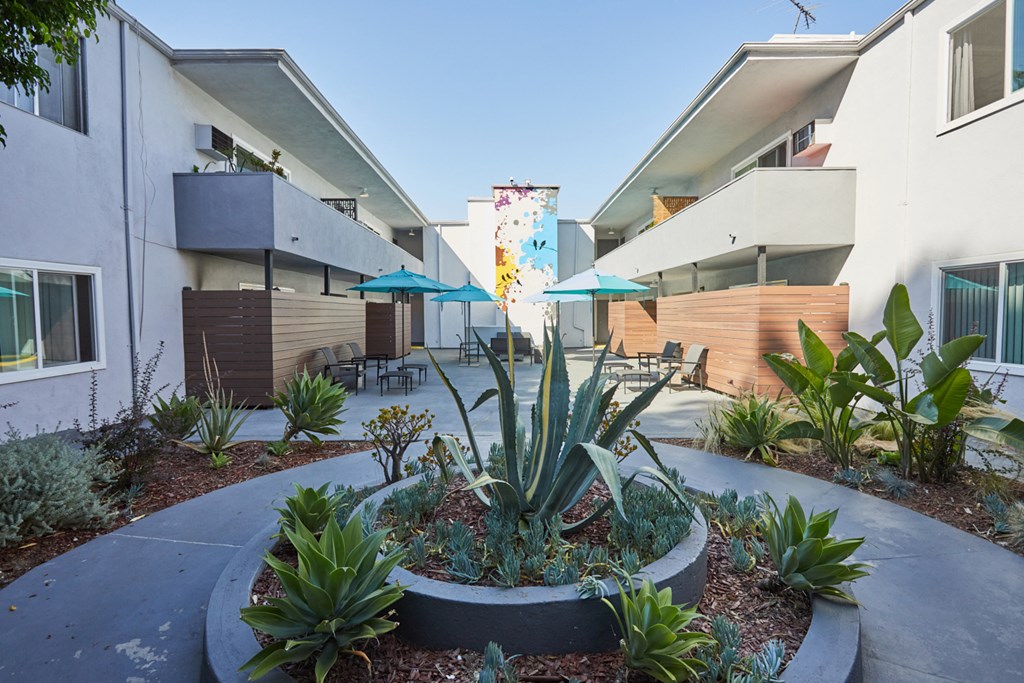 Outdoor courtyard with greenery and patios