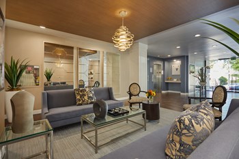 Spacious lobby with seating areas and adorned in beautiful tones of yellow, grey, and brown - Photo Gallery 11