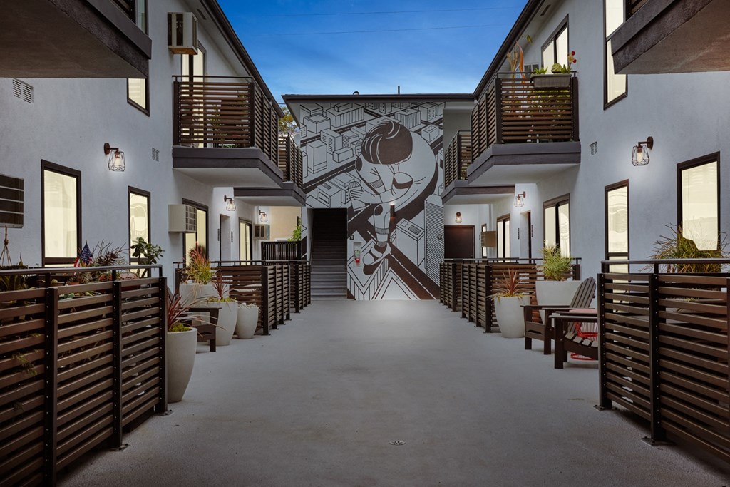 Evening in the courtyard with units and patios all lit up