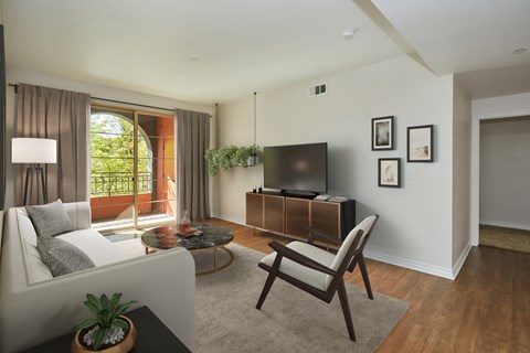 Beautiful spacious living area with glass door leading onto patio