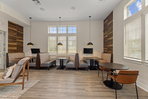 A modern dining room with a wooden table and chairs.