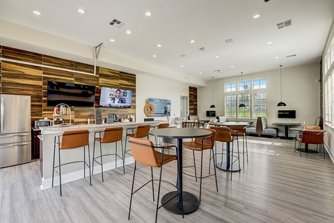 A modern kitchen with a dining table and chairs.