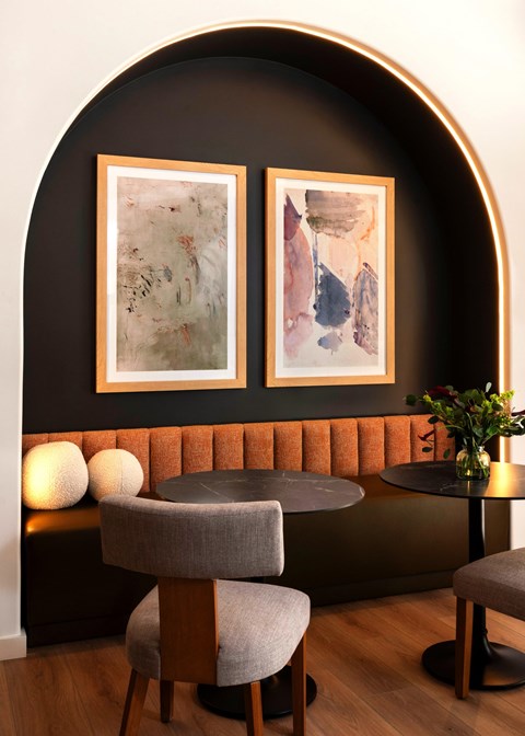 A modern dining area with a round table and two chairs.