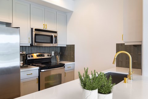 A kitchen with a stove top oven and a microwave above it.
