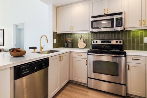 A modern kitchen with a stainless steel oven and microwave.