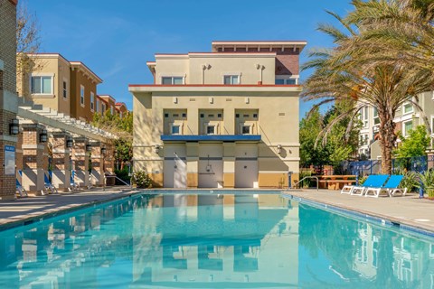a swimming pool with a building in the background