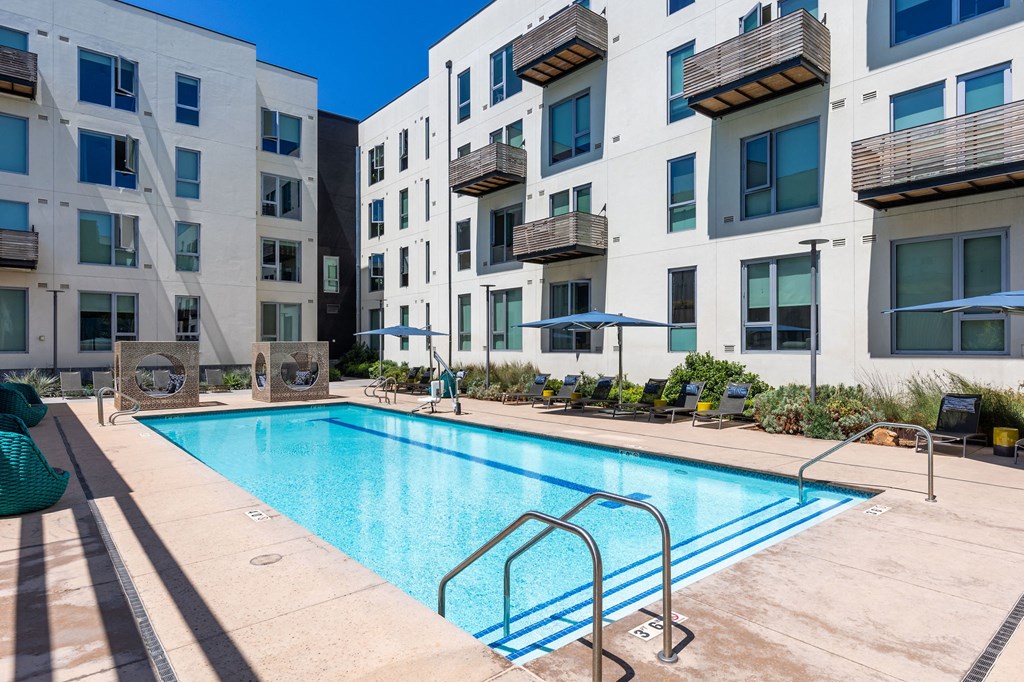 a swimming pool in front of an apartment building