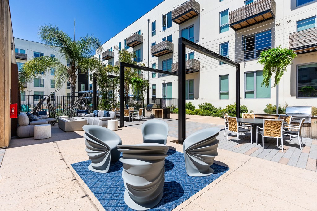 a patio with chairs and tables at the bradley braddock road station apartments