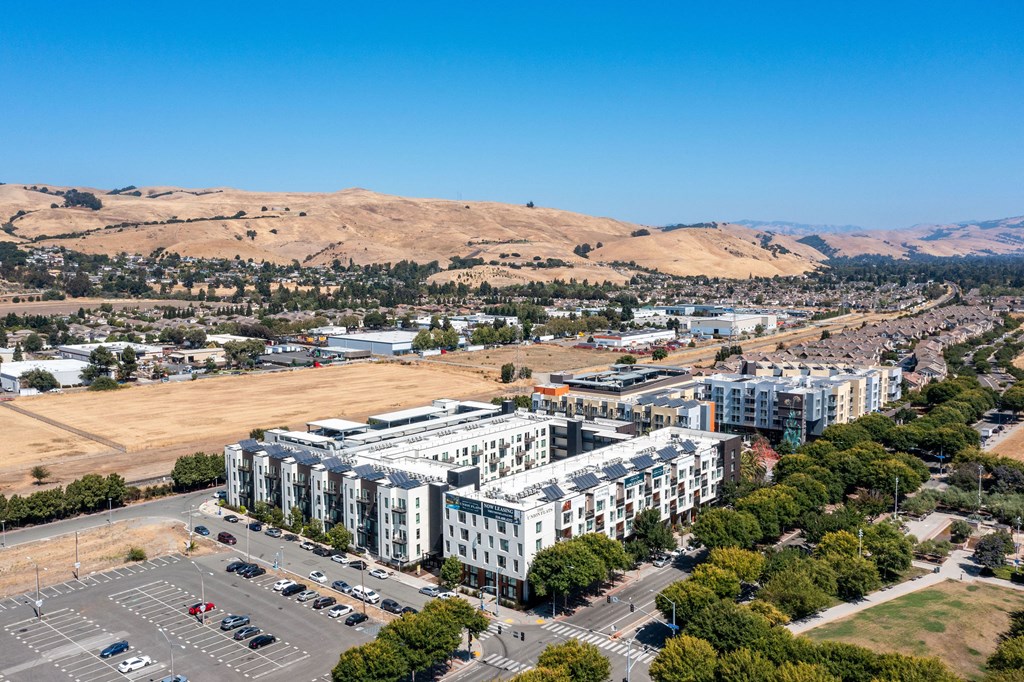 an aerial view of a large city with hills in the background