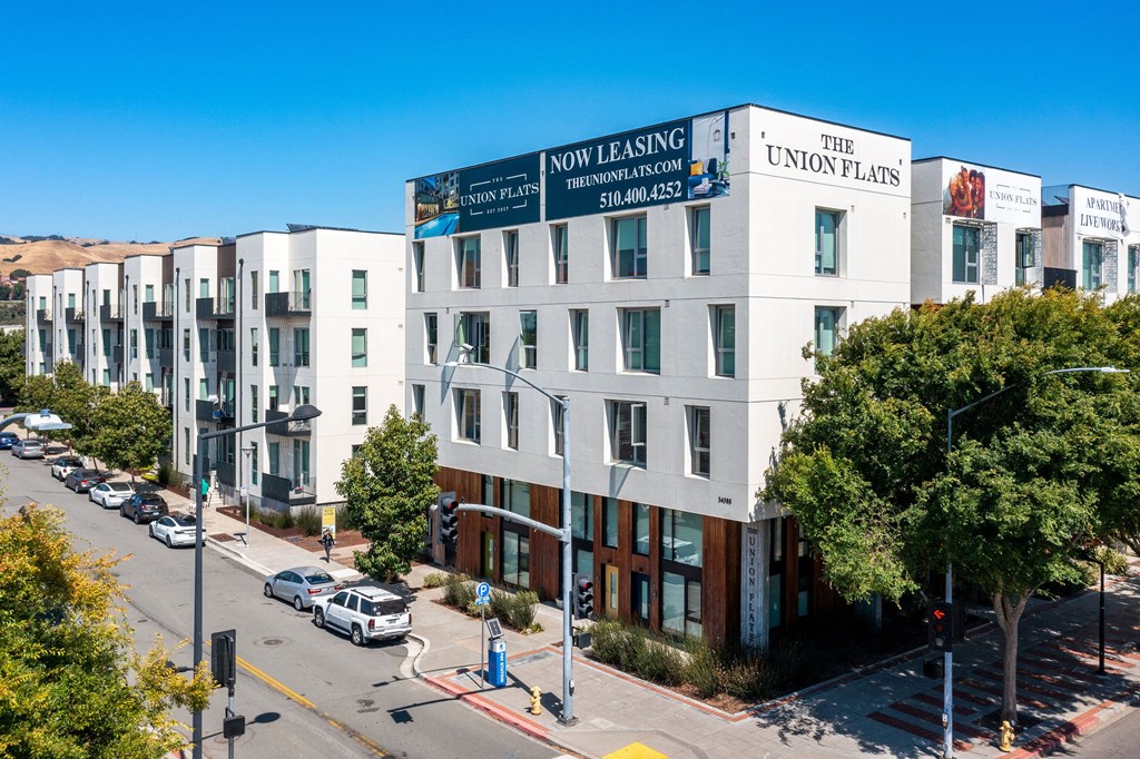 a large white building with a blue sign on top of it