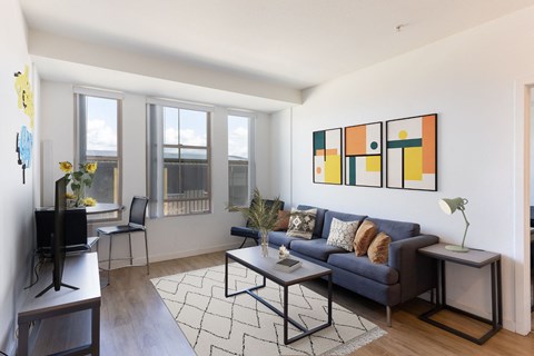 a living room with a blue couch and a tv