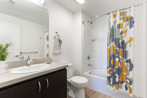 a bathroom with a shower and a sink and a toilet