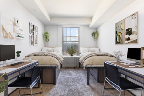 two beds in a room with two desks and a television