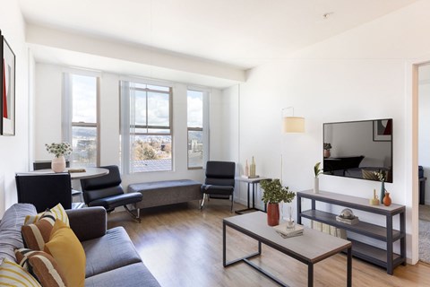 a living room with a couch and a table and a television