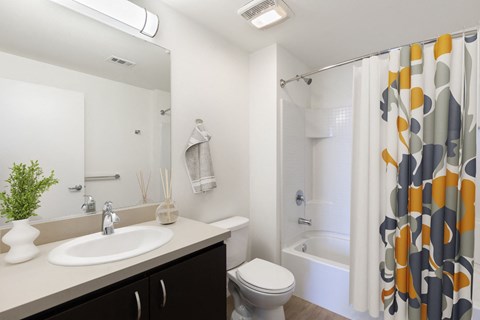 a bathroom with a shower and a sink and a toilet