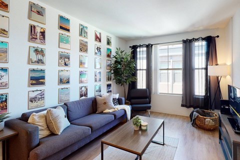 a living room with a couch and a coffee table in front of a wall covered