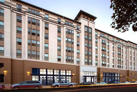 a large building with cars parked in front of it