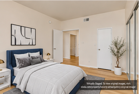 A bedroom with a large bed and a blue headboard.