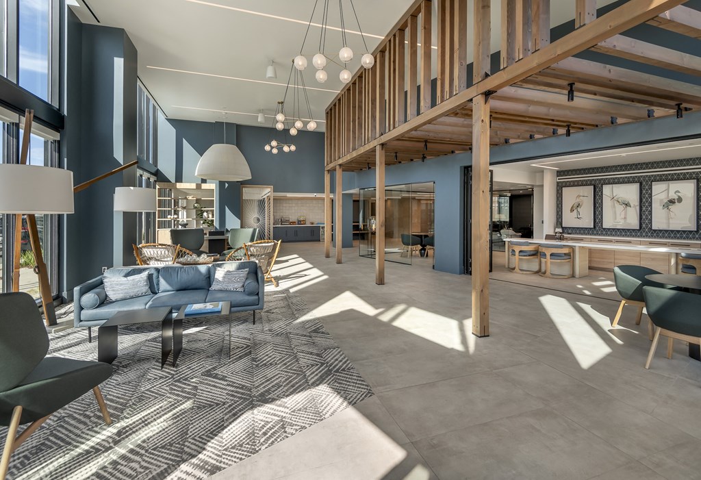 a large lobby with couches chairs and tables and a staircase