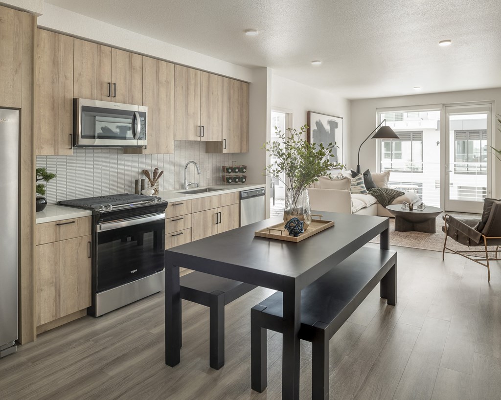an open kitchen and living room with a dining table