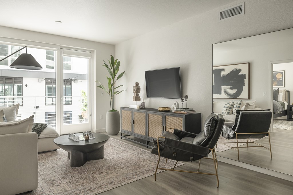a living room with a couch and a chair and a television