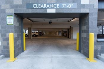 the entrance to a parking garage with yellow barriers at Pinnex, Indianapolis, 46203