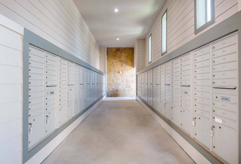a row of lockers in a long room with a stone wall at Discovery at Craig Ranch, McKinney, Texas