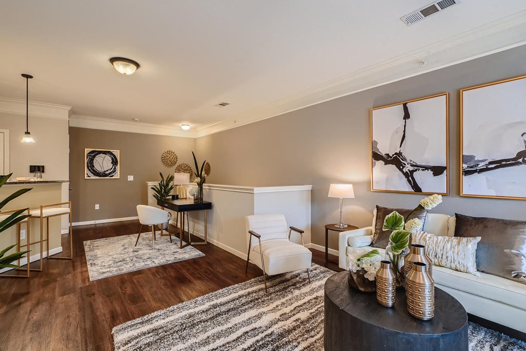 a living room with a couch and a table  at Grand Villas Apartments, Texas