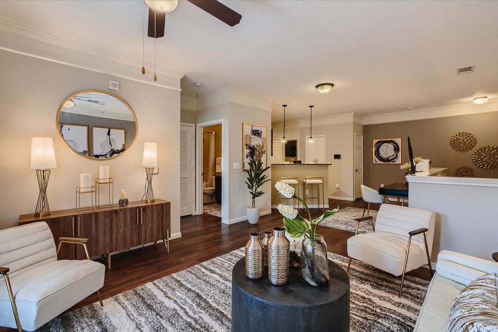 a living room with a couch and a table  at Grand Villas Apartments, Katy, TX, 77494