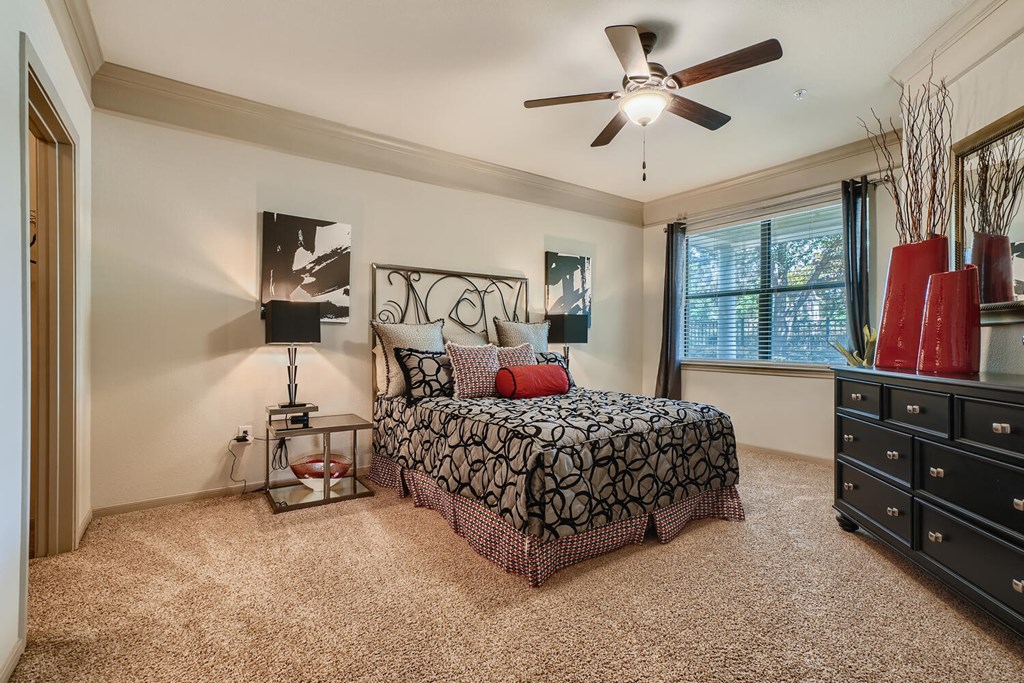a bedroom with ceiling fan and walk-in closet  at Grand Villas Apartments, Texas, 77494
