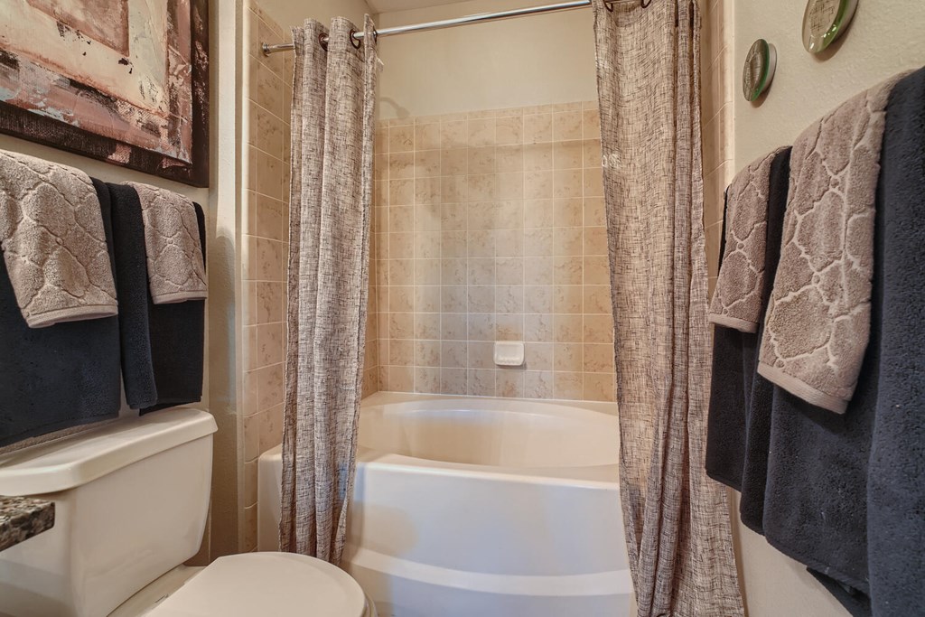 a bathroom with matching towels and finishes at Grand Villas Apartments, Katy, TX, 77494